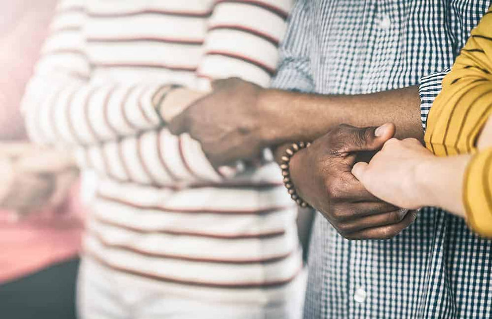 Creative team meeting hands together in line. Young business people are holding hands. Unity and teamwork concept.