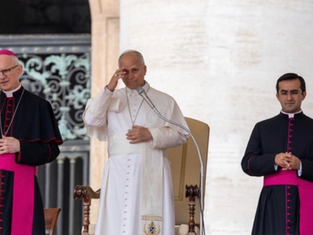 Pope in white robe salutes at a podium, flanked by two black-and-magenta clergy in a solemn ceremony.