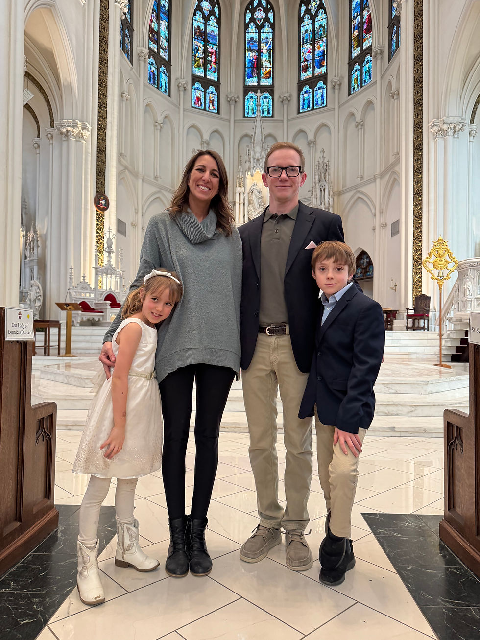 Family of four posing in a bright church with stained glass and ornate white columns. The mood is joyful and elegant.