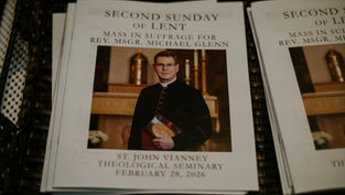 Mass program featuring a priest in black robes, gold church altar in background. Text: Second Sunday of Lent, Feb 28, 2026.