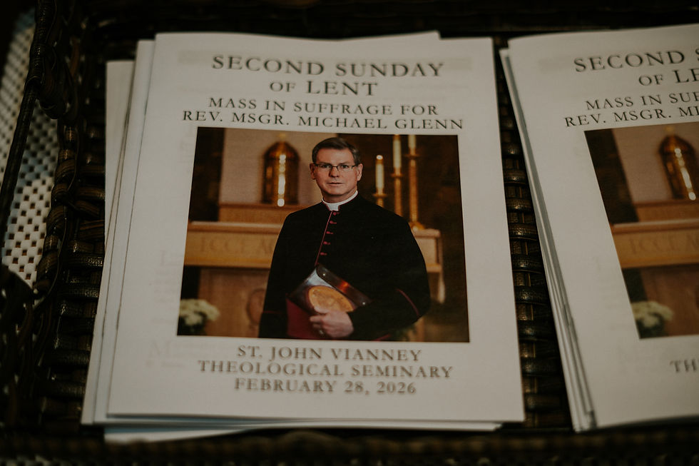 Mass program featuring a priest in black robes, gold church altar in background. Text: Second Sunday of Lent, Feb 28, 2026.
