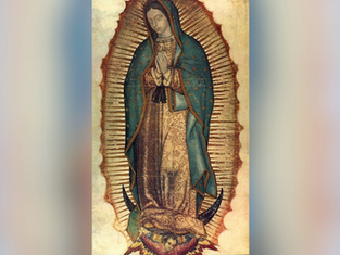 A woman in a blue starry cloak and floral robe prays, surrounded by a golden aura. She stands on a crescent moon, with an angel below.