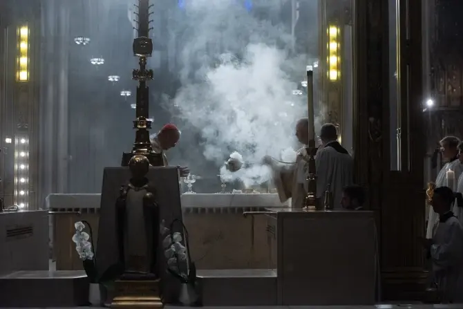 Clergy perform a ritual with incense smoke in a dimly lit cathedral. Ornate altar with white flowers; solemn and reverent atmosphere.