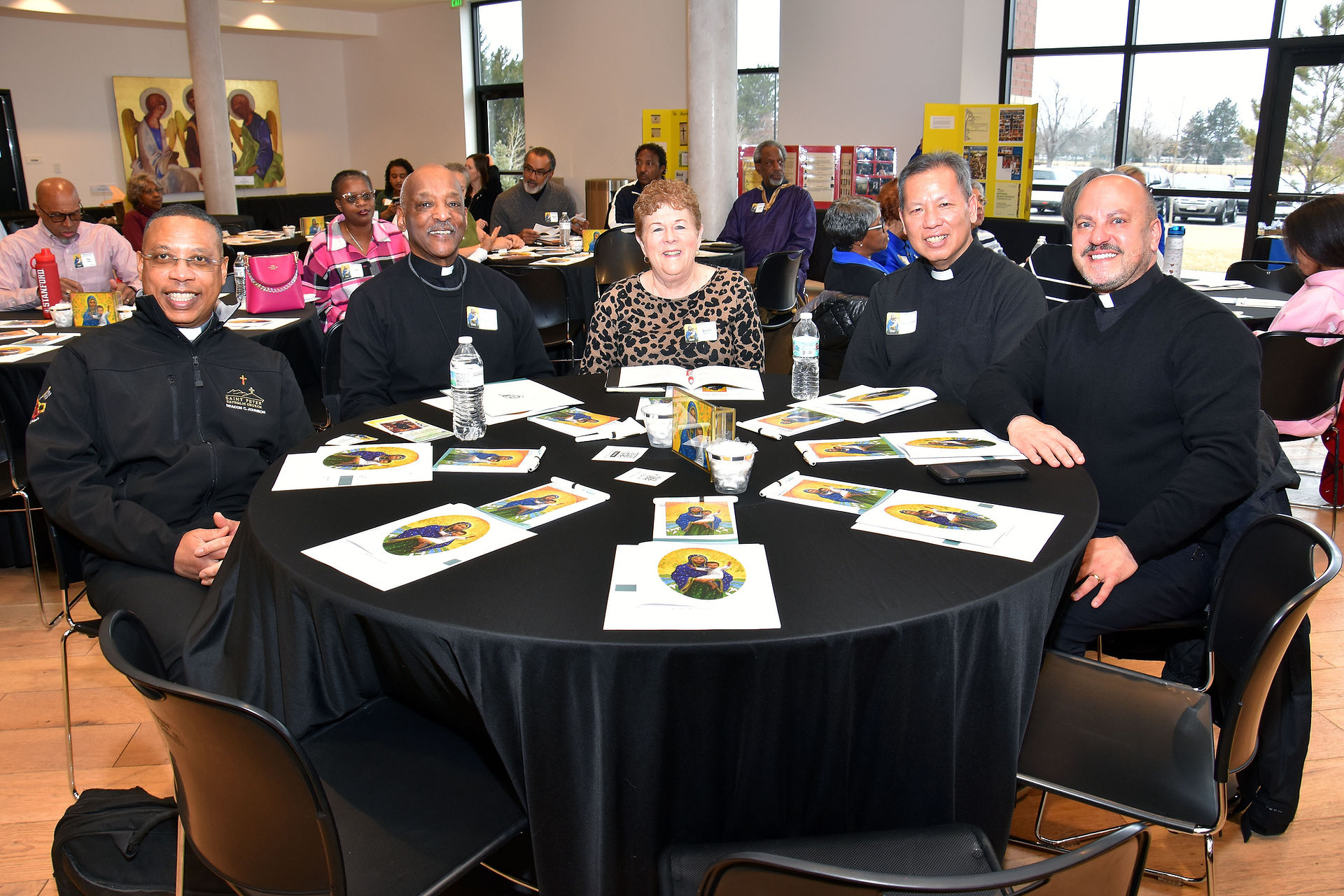Wanda McDavid with various members of the clergy, including her husband, Deacon Clarence McDavid (Photo by James Baca)