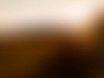 Red-haired person in a field at sunset, running with arms outstretched. Warm golden light and carefree mood.