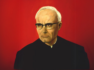 Portrait of an elderly man with glasses wearing dark clothing against a vivid red background, expressing a serious demeanor.