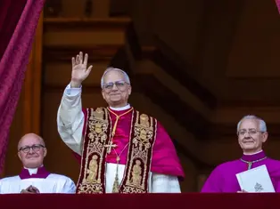 Three clergymen in ornate robes stand on a balcony. The central figure waves, flanked by two smiling men. Maroon curtains frame the scene.