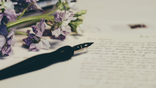 Purple flowers and a fountain pen rest on handwritten letters, evoking a nostalgic and thoughtful mood.