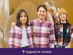 Three people in plaid shirts smile in front of a wooden wall and holiday decor. Text below reads "Appeal in Action" on a purple banner.