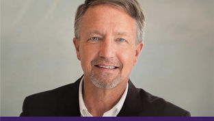 Smiling man in a suit against a neutral background. Text: "Appeal in Action" on a purple banner below. Mood is professional and friendly.