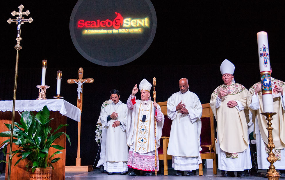 Clergy in ceremonial robes on stage, one bishop raising hand in blessing. Lit candles and cross in foreground, "Sealed & Sent" logo above.