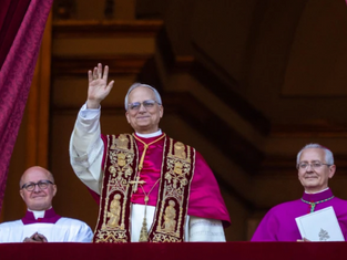 Three clergy on a balcony; central figure waves, wearing ornate robes. Red drapes frame them, creating a formal, uplifting scene.