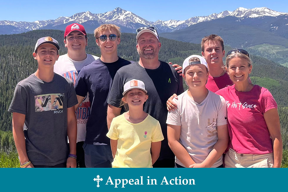 A group of eight smiling people outdoors with snowy mountains in the background. Text on shirts and "Appeal in Action" on the image.