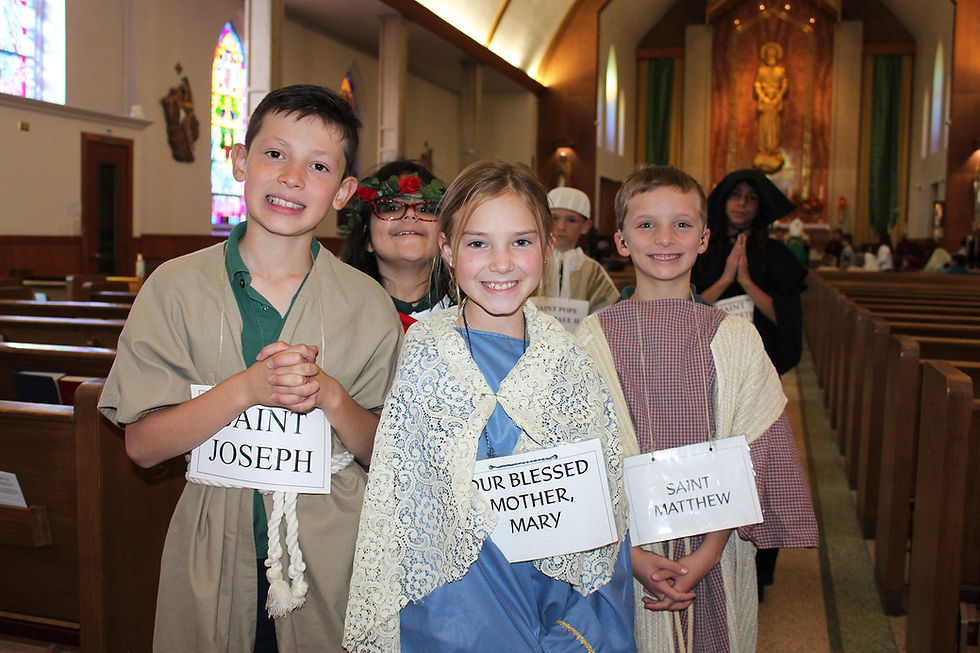 Children in costumes, labeled as saints, smile in a church with stained glass windows. Joyful atmosphere with vibrant colors and warm lighting.
