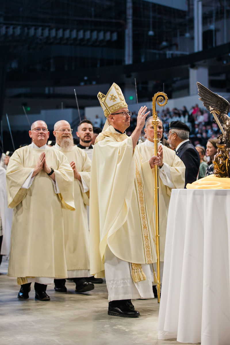The bishop offers a blessing during the installation Mass procession.
