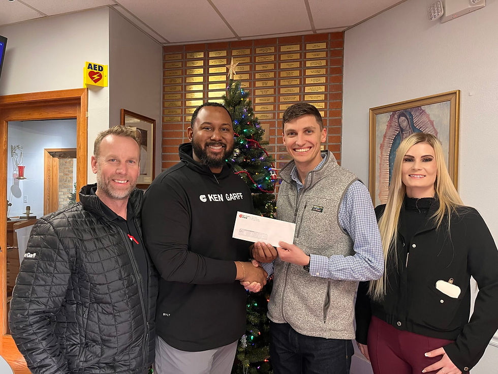 Members of the Ken Garff team present a check to Nolan O'Keefe, a member of the Catholic Charities Mission Advancement team. (Photo provided)