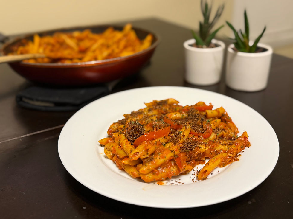 A plate of Roasted Red Pepper Pasta topped with oregano breadcrumbs, garnished for an appetizing presentation, perfect for Lent.