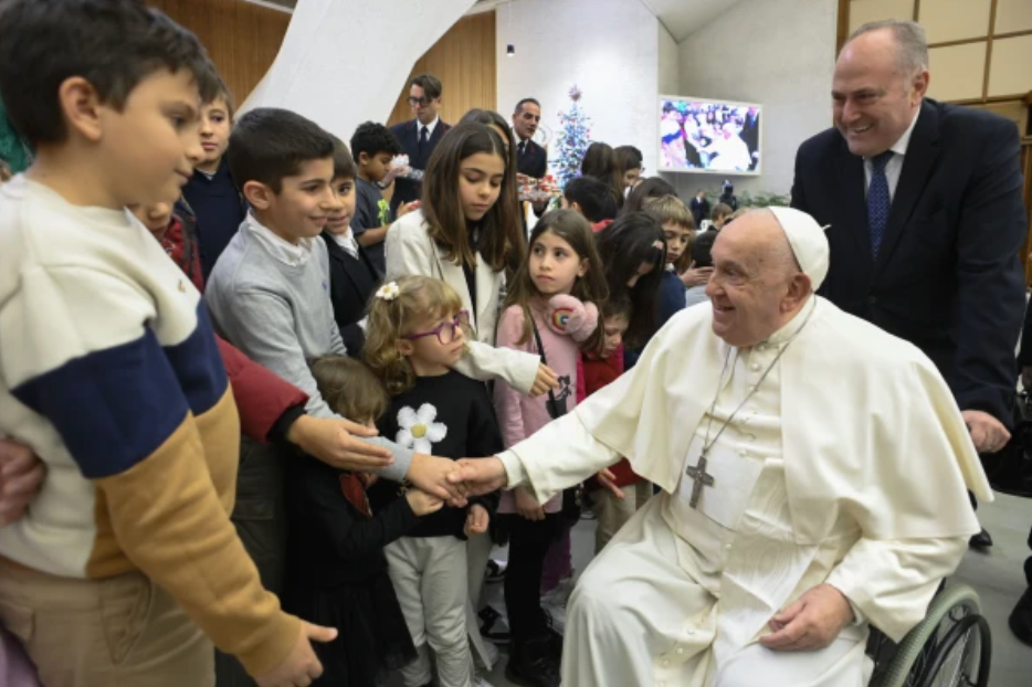 Pope Francis greets children of Vatican employees during the annual Christmas gathering in the Vatican's Paul VI Hall, Dec. 21, 2024. (Photo: Vatican Media)