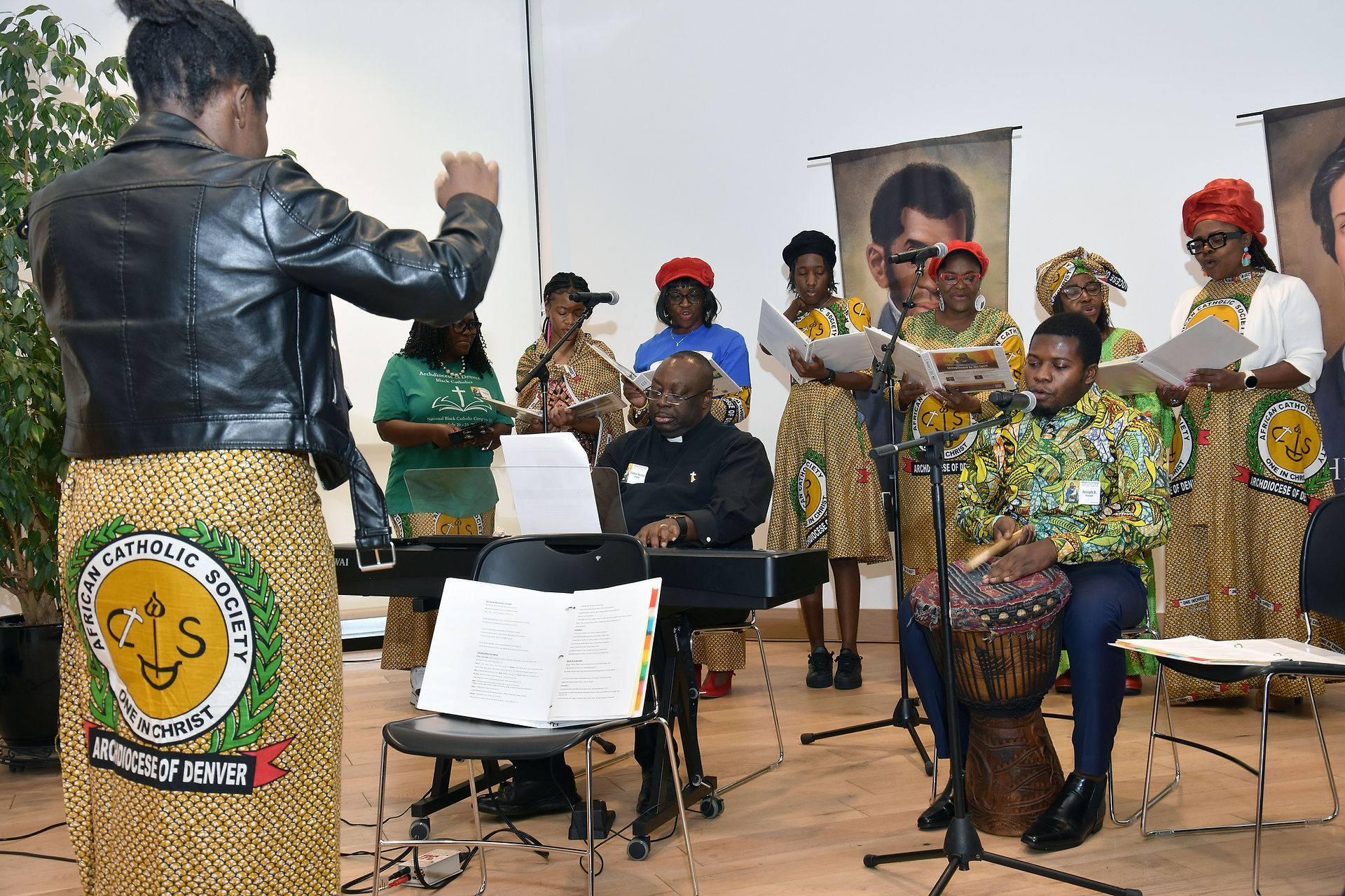 Father Austin Okigbo and the African Catholic Society Choir. (Photo by James Baca)