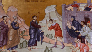 Ancient mural depicting a haloed figure extending a hand to a man in red. Others watch nearby. Text in Cyrillic above. Earthy tones.