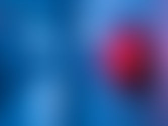 Red alarm light on a blue wall in a corridor, glowing brightly. The background is blurred, creating a tense, urgent mood.