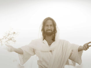 Man with open arms and a serene smile, wearing a white robe, in a bright, soft-focus setting. Peaceful and inviting mood.