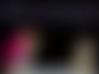 A bishop in pink and white attire kisses a gold object in a dimly lit space. Candles and a crucifix are on the altar. solemn mood.