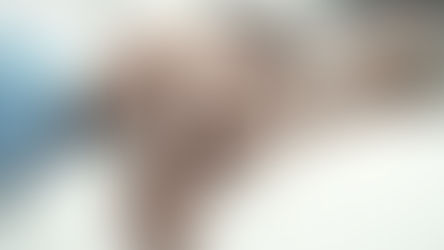 Hands of an elderly person being gently held by a younger person on a white blanket, conveying warmth and care in a soft-focus setting.