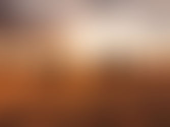 Five cloaked figures walk across desert dunes toward a glowing sunset, their long shadows stretching behind them.