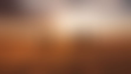 Five cloaked figures walk across desert dunes toward a glowing sunset, their long shadows stretching behind them.