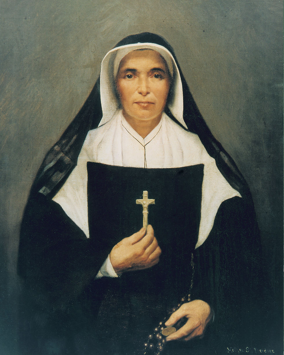 Portrait of a solemn nun in black-and-white habit holding a crucifix and rosary against a gray background.