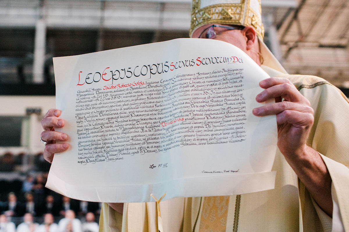 Close-up of the bishop displaying the apostolic mandate during the ceremony.