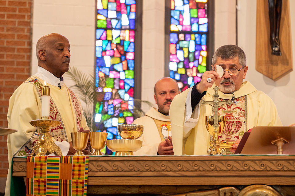Clergy in ornate robes conduct a religious ceremony, holding a chalice and wafer. Stained glass windows create a colorful backdrop.