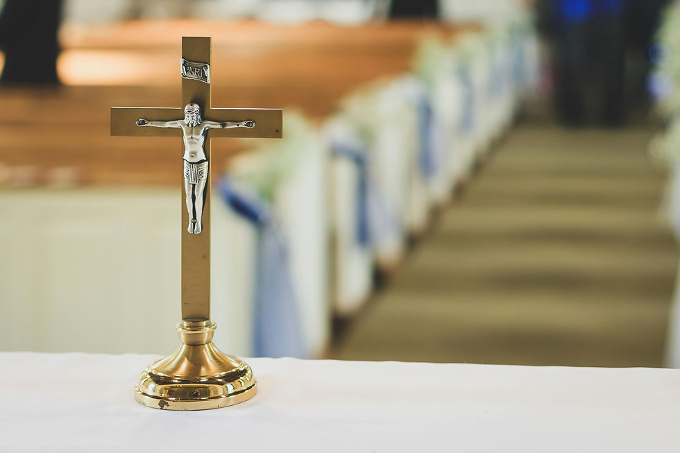 Gold crucifix with silver Jesus figure on an altar, blurred church aisle in the background, evoking a serene and reverent mood.
