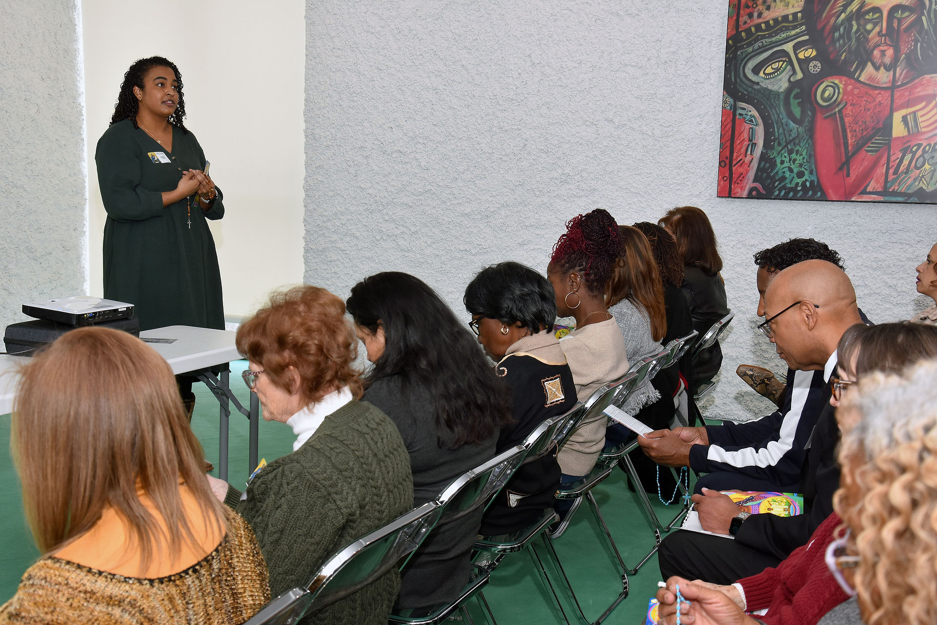 Sophia Parnell leads participants in praying the Rosary. (Photo by James Baca)