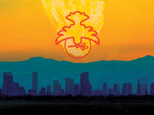 Silhouette of a cityscape with a symbol above, set against a vibrant yellow and orange sky, creating a warm, abstract ambiance.