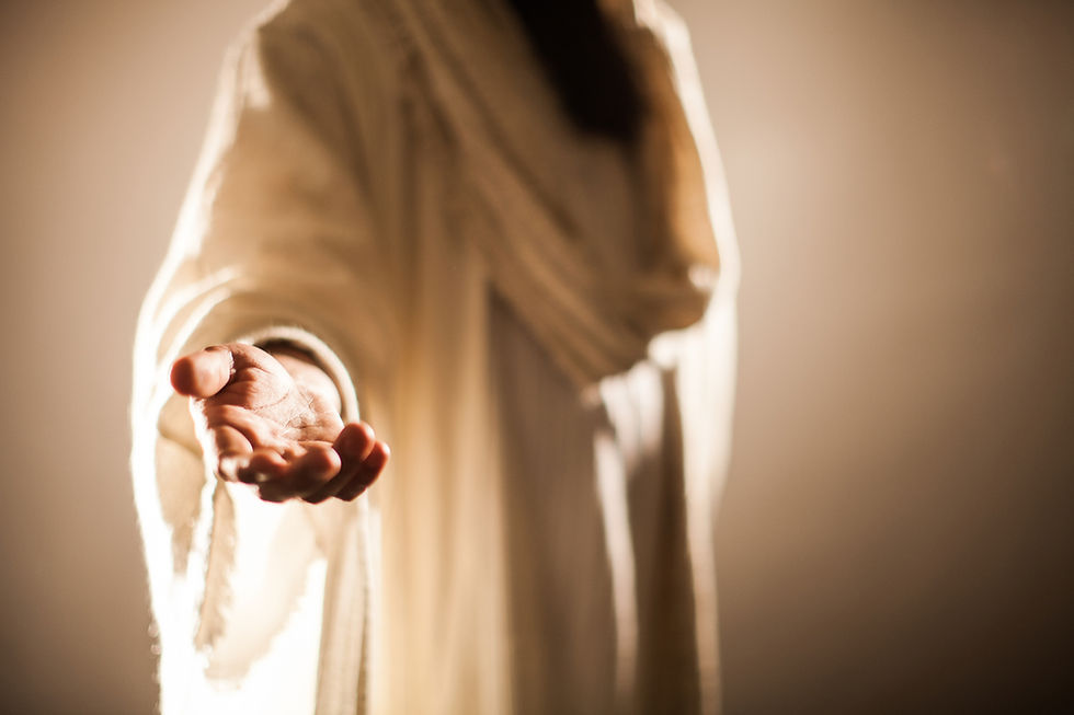 Outstretched hand in a flowing, cream-colored robe, reaching forward in soft lighting. Background is blurred, creating a serene atmosphere.