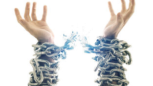 Hands bound in metal chains breaking free against a white background. Chains shatter, symbolizing liberation and strength.