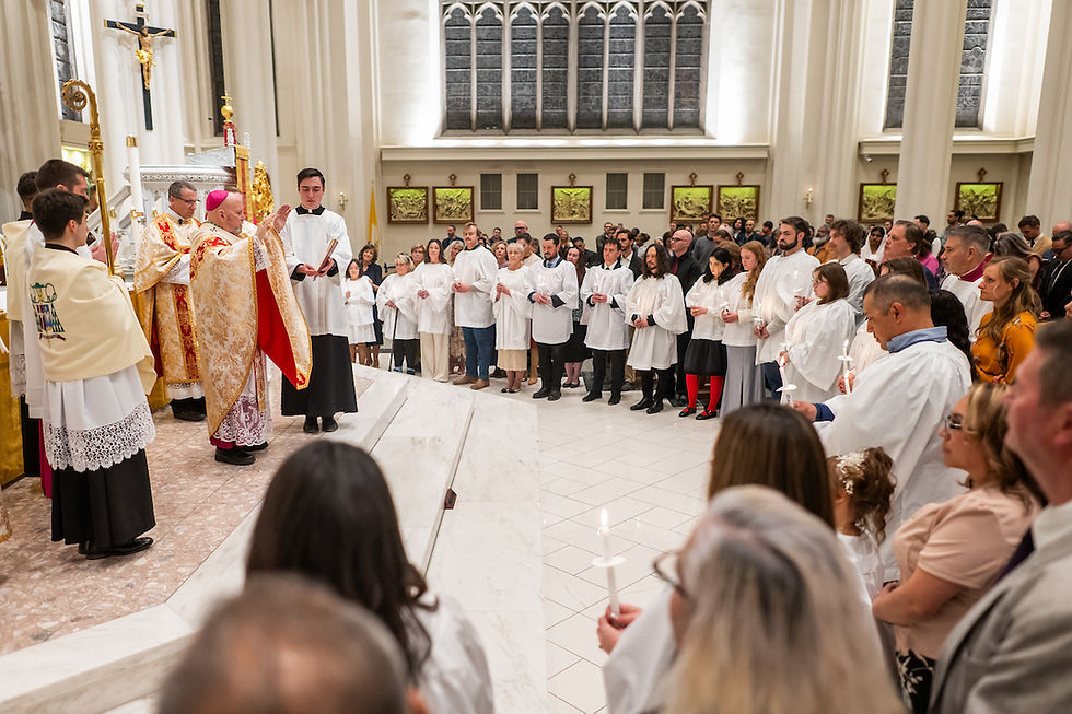 A priest blesses a congregation in white robes holding candles. The ceremony takes place in a bright church with tall windows and golden decor.