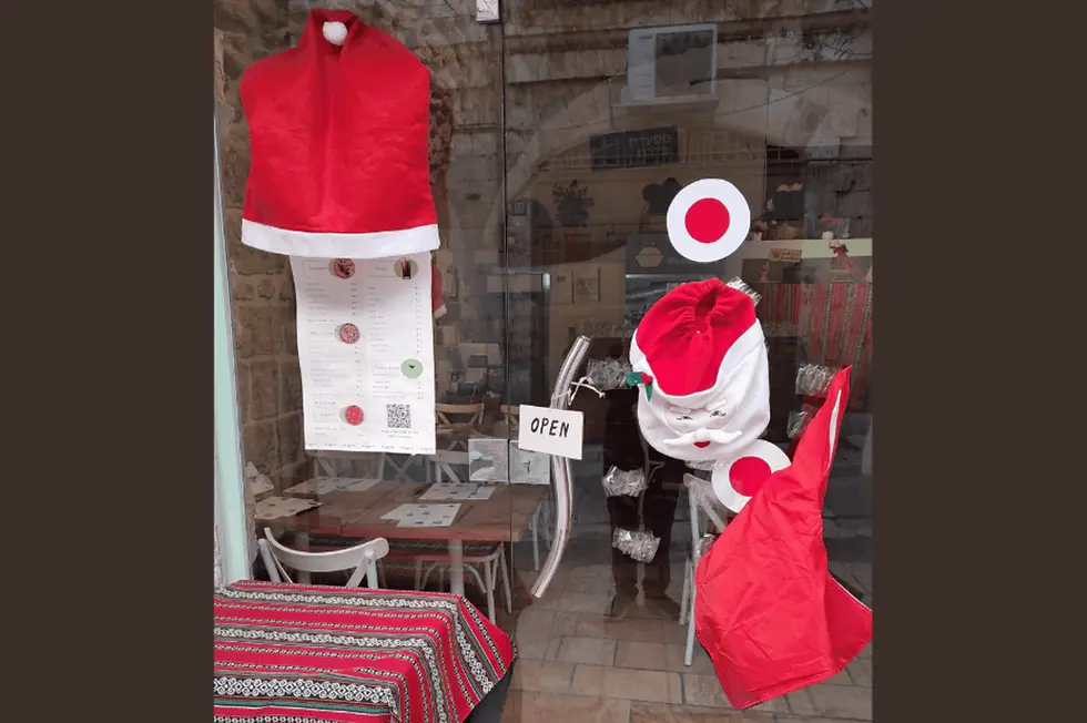 A restaurant in Jerusalem's Christian Quarter is decked out for Christmas, but there are almost no tourists. (Photo: Michele Chabin)