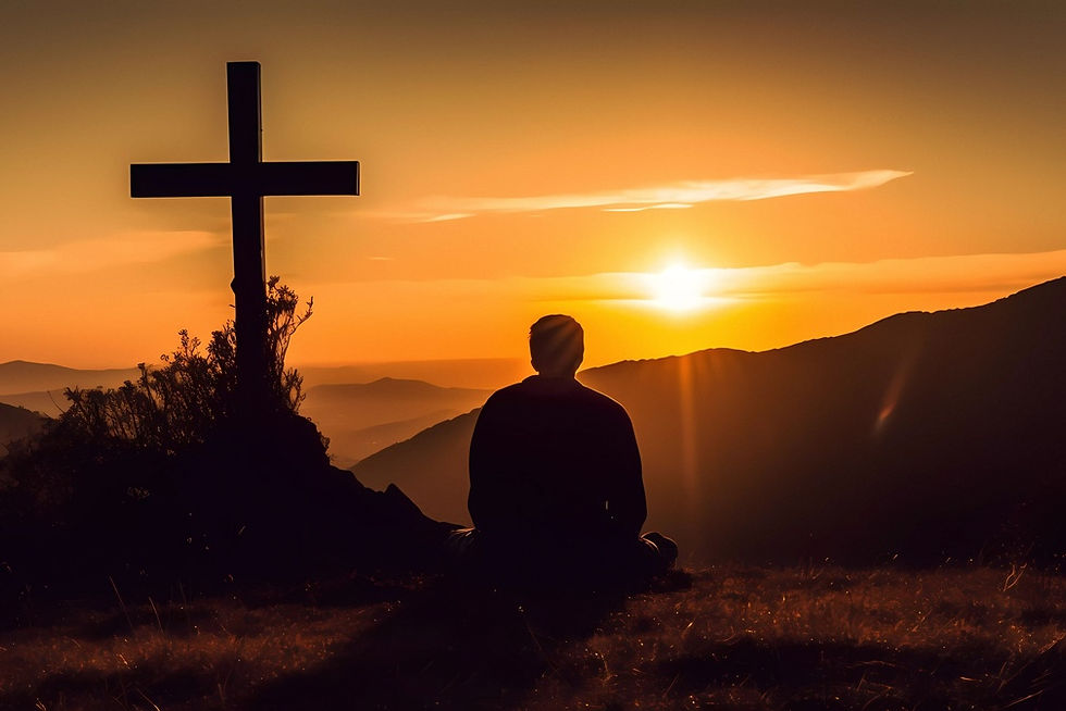 Silhouette of person sitting near a cross, gazing at a vibrant orange sunset over hills, creating a serene and contemplative mood.