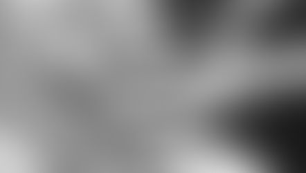 Hands gently holding another's in a comforting gesture. A ribbon is tied around one wrist. Monochrome image conveys warmth and care.