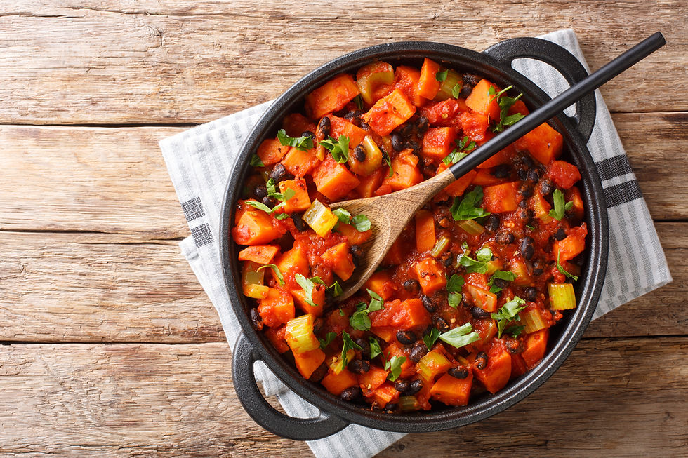 Cast iron skillet filled with fresh vegetables and black beans, showcasing a hearty Sweet Potato Black Bean Chili for Lent.