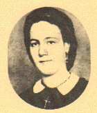 Vintage sepia portrait of a woman in an oval frame, wearing a dark dress with a white collar, against a textured background.