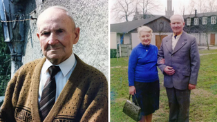 Elderly man in brown sweater outside; couple standing together on grass, woman in blue sweater with handbag. Background has buildings, trees.