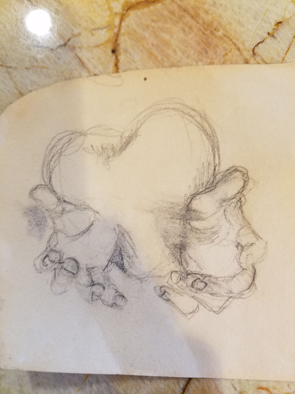 Pencil sketch of entwined elephants on aged paper. The background features a marbled surface with earthy tones, creating a vintage feel.