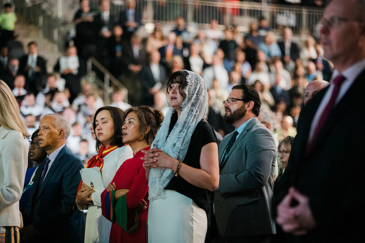 Members of the congregation pray attentively during the Mass.