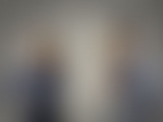 A confused man and woman use tin can phones; question marks fill the gray background, suggesting misunderstanding.