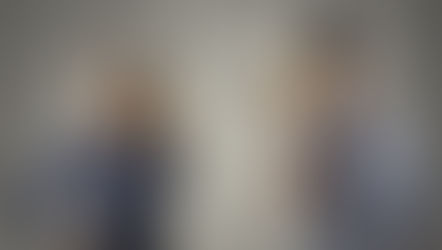 A confused man and woman use tin can phones; question marks fill the gray background, suggesting misunderstanding.