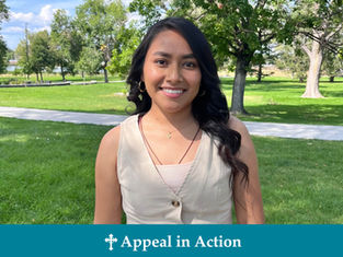 Smiling woman in a cream top stands in a sunny park with green grass and trees. Blue banner at bottom reads "Appeal in Action."